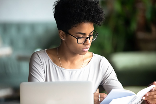 Female sat at laptop with an application form
